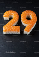 Salmon sushi shaped as number twenty nine on black slate