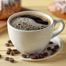 Delicious Coffee in a White Cup with Roasted Beans on Wooden Plate