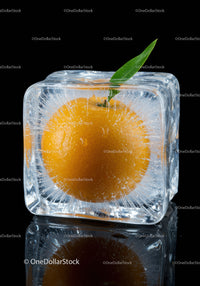 Fresh orange encased inside a crystal clear ice cube