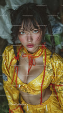 Young Woman with Wet Hair Wearing Bright Yellow Outfit with Red Rope