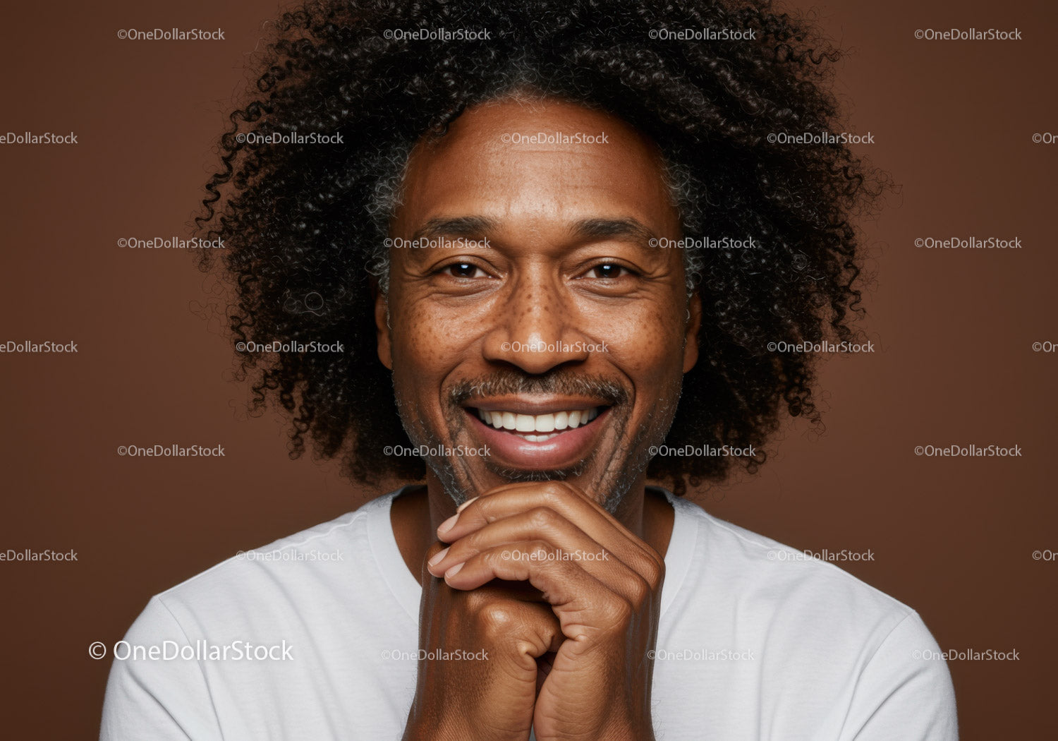 Happy Man with Curly Hair Smiling in Studio Portrait