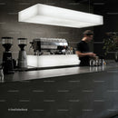 Barista preparing coffee in modern minimalist cafe interior