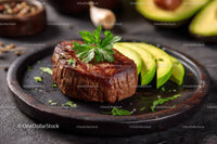 Fresh Grilled Steak with Sliced Avocado and Herbs on Rustic Plate