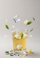 Refreshing iced jasmine tea with fresh flowers and leaves