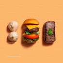 Gourmet Burger with Lettuce and Tomato Next to Grilled Steak and Dumpling