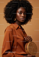 Elegant Black Woman Wearing Brown Blouse with Woven Handbag