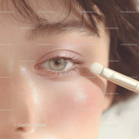 Close-up of Eye with Concealer Brush and Soft Skin