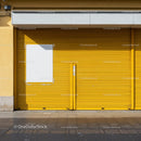 Closed yellow garage door with blank white poster