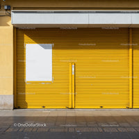 Closed yellow garage door with blank white poster