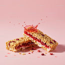 Berry Filled Cereal Bars with Splash on Pink Background