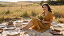 Young woman in mustard dress holding wildflowers outdoors