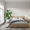 Scandinavian Bedroom with Monstera Plant and Cozy Bedding