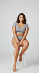 Stylish Casual Woman Sitting on Stool Indoor Studio Portrait