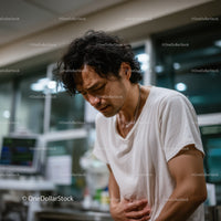 Man with Stomach Pain Feeling Discomfort in Indoor Environment