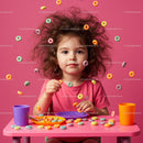 Curly-haired child playing with colorful cereal rings