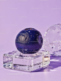 Close up of blueberry on ice cube with lavender background