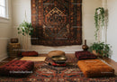 Cozy meditation corner with floor cushions and plants