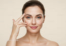 Beautiful Woman Performing Facial Skincare Routine with Marked Highlights