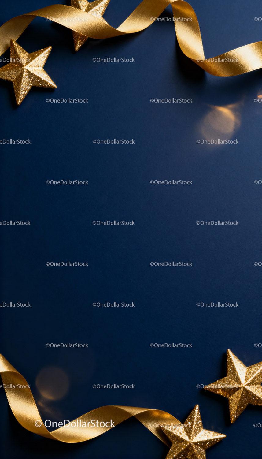 Festive golden stars and ribbon on dark blue background
