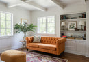 Cozy living room with orange sofa and natural light