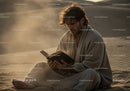 Serene Man Reading Book on Desert Sand Dune During Sunset