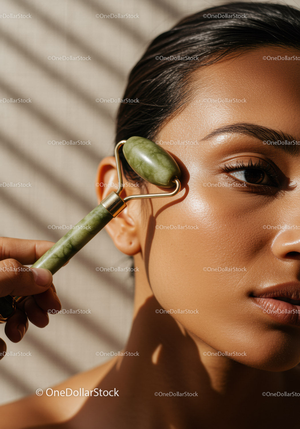 Close-up of Woman Using Jade Roller for Facial Massage with Beautiful Skin