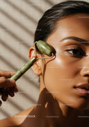 Close-up of Woman Using Jade Roller for Facial Massage with Beautiful Skin