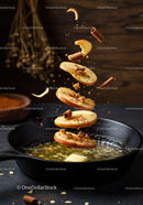 Sautéed apple slices with cinnamon and butter in pan