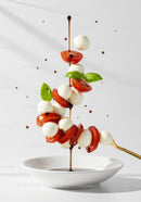 Fresh Caprese Salad Ingredients Floating Over Bowl