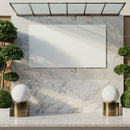 Modern marble outdoor wall with spherical sculptures and greenery