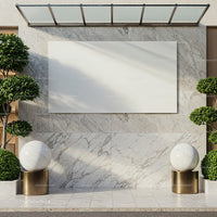 Modern marble outdoor wall with spherical sculptures and greenery