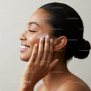Young Woman Applying Face Moisturizer for Radiant Skin