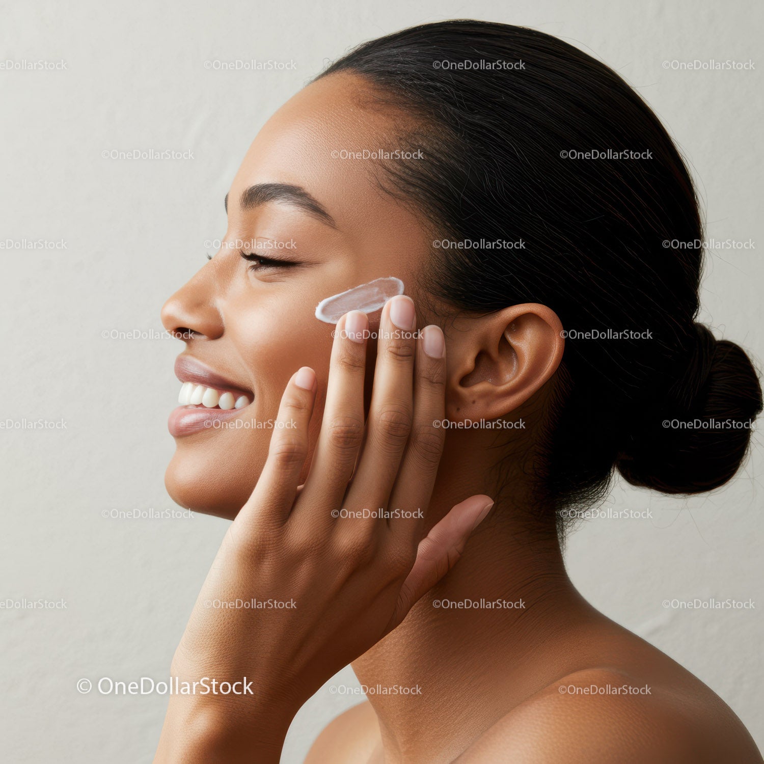 Young Woman Applying Face Moisturizer for Radiant Skin
