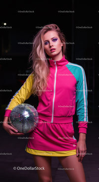 Vibrant Young Woman in Colorful Sportswear Holding Disco Ball