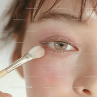 Close-Up of Woman Applying Eye Makeup with Brush