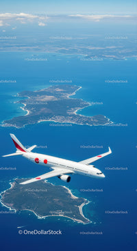 Aerial View of Island and Ocean with Airplane in Sky