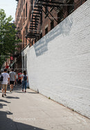 City Sidewalk with Pedestrians and Tree Shadows