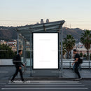 Urban bus stop with blank billboard and moving people