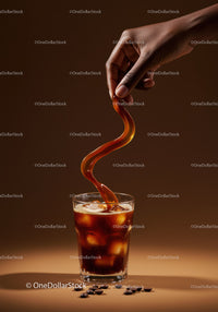 Refreshing iced coffee with swirling pour and coffee beans