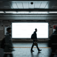 Commuters walking past a blank subway advertisement