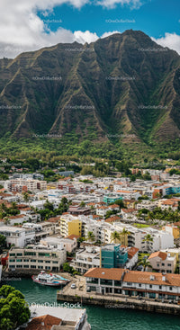 Lush Mountain Range Over Tropical Coastal Town with Colorful Buildings