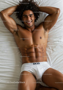 Relaxed young man lying on bed with white briefs