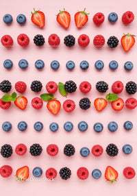 Colorful fresh berries and mint leaves on pink background