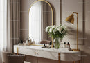 Elegant vanity table with floral decor and golden lamp