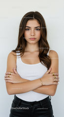 Confident Young Woman in White Tank Top with Gold Jewelry