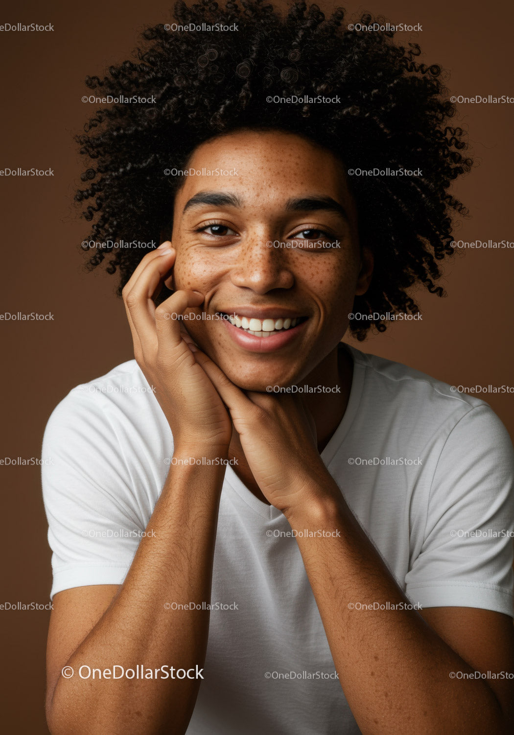 Young Man with Curly Hair and Freckles Smiling in Studio Portrait