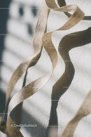 Close-up of White Plastic Ribbon Waste on Sandy Beach