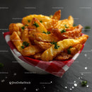 Golden Potato Fries Garnished with Fresh Parsley in a Red and White Basket