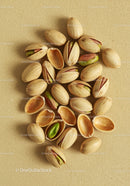 Close up of pistachio nuts on textured fabric background