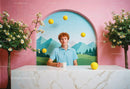 Young Man Sitting at Artistic Mountain Scene with Tennis Balls and Cherry Blossoms